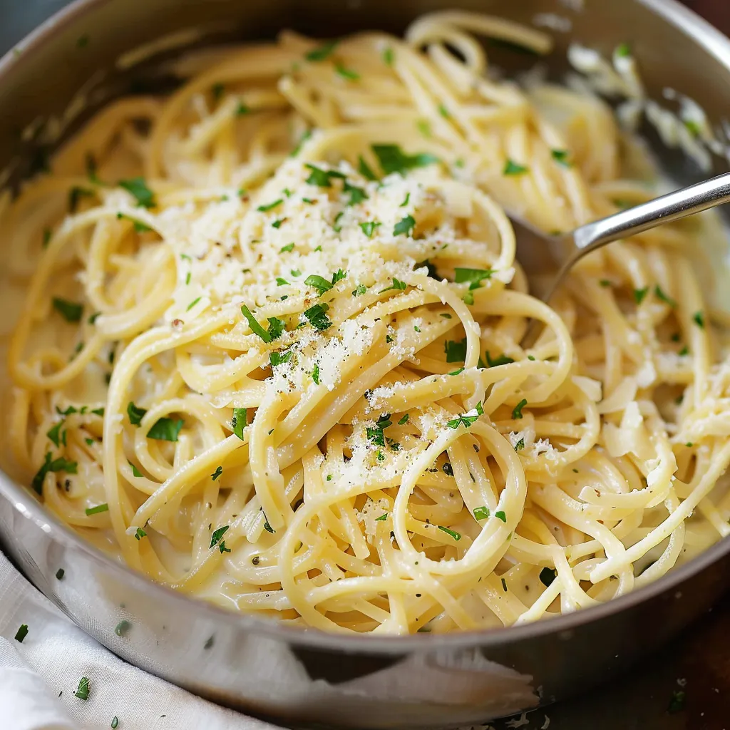 A bowl of pasta with cheese and herbs.