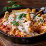 A cheesy ziti pasta served in a bowl.