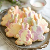 A plate of bunny-shaped cookies decorated with bright colors.