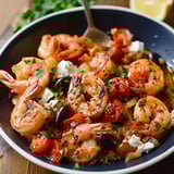Shrimp and vegetables in a bowl on a wooden table.