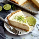 A dessert plate with a slice of lime pie and a fork.